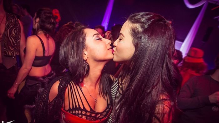 Girls kiss in a swingers club in Israel